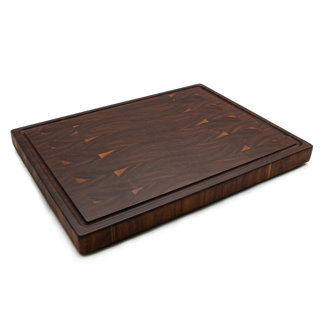 End grain walnut cutting board with a juice groove, 20 x 15 in, angled view showing the 1.5 inch edge