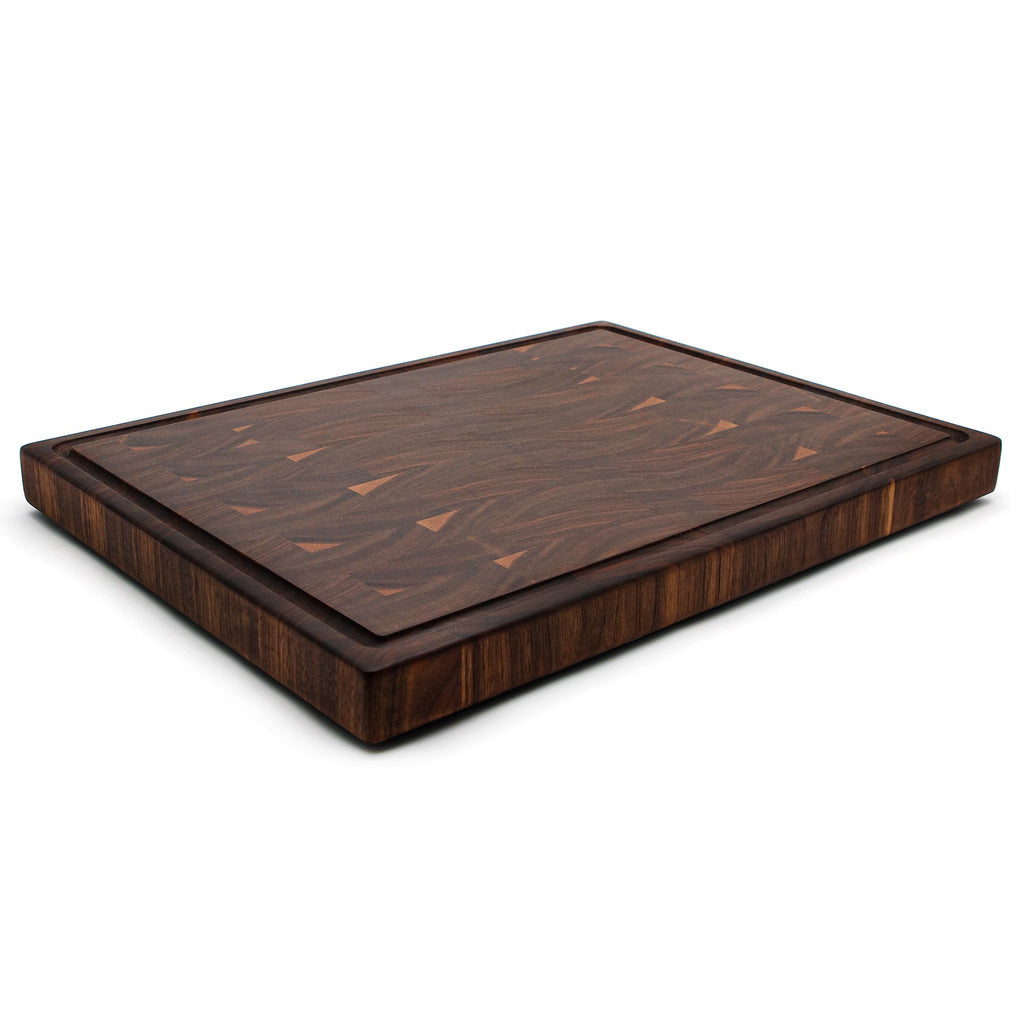 End grain walnut cutting board with a juice groove, 20 x 15 in, low angled view from the far corner