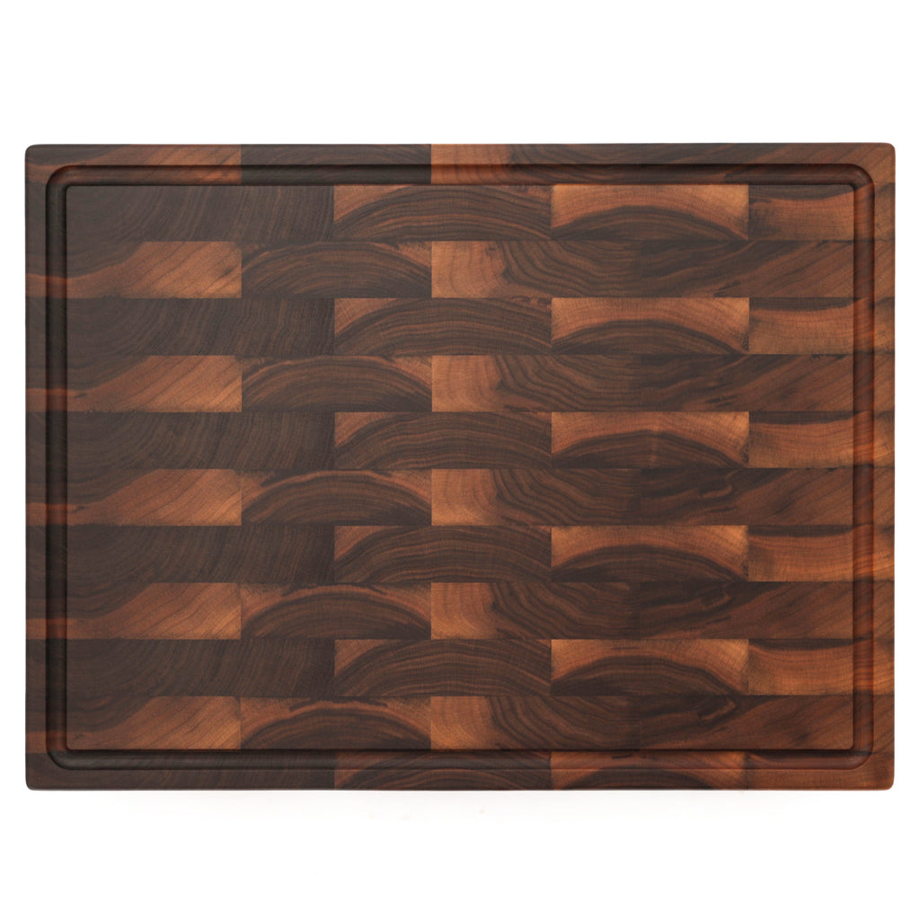 End grain walnut butcher block with a juice groove, 24 x 18 in, straight overhead view on white