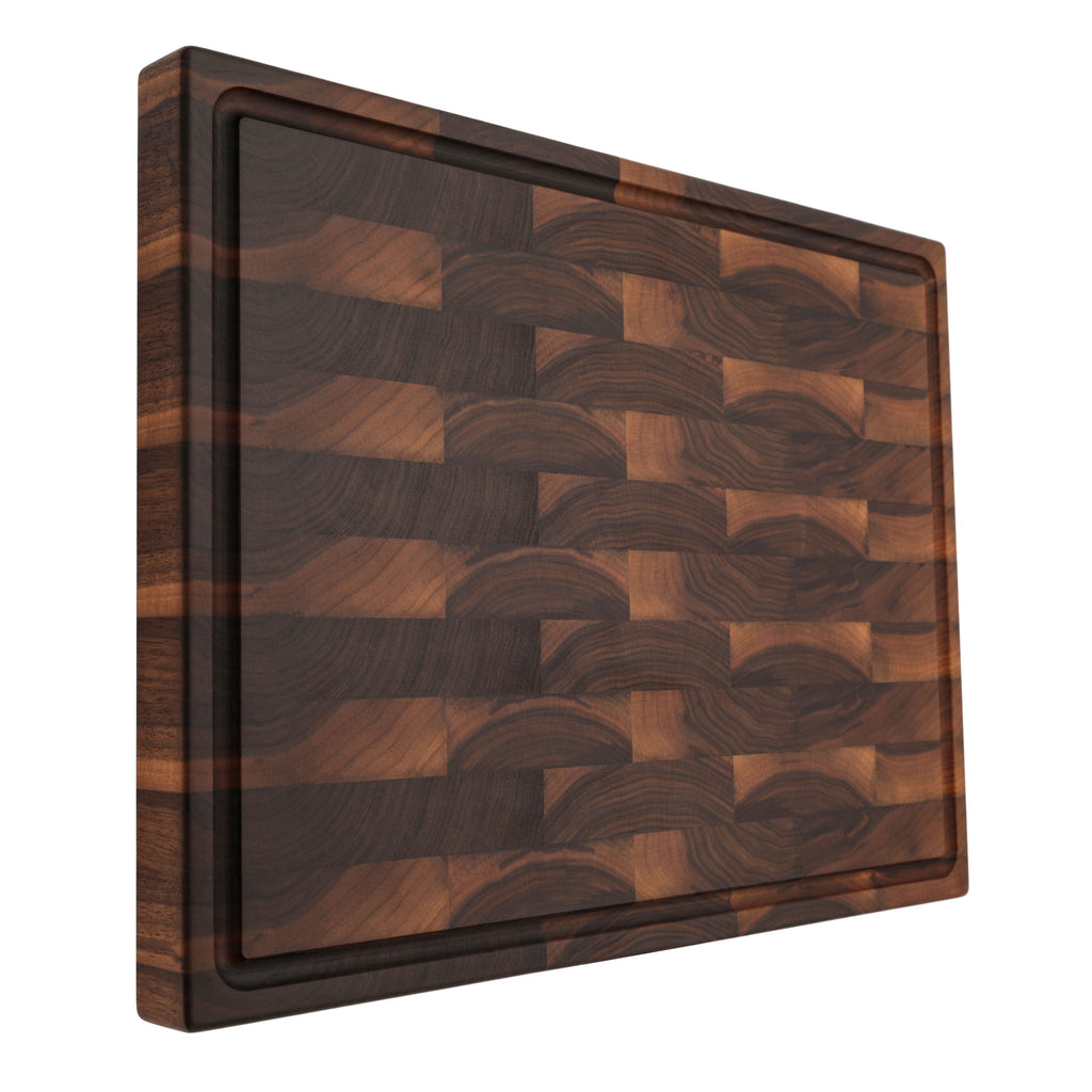 End grain walnut butcher block with a juice groove, 24 x 18 in, propped upright at an angle on white
