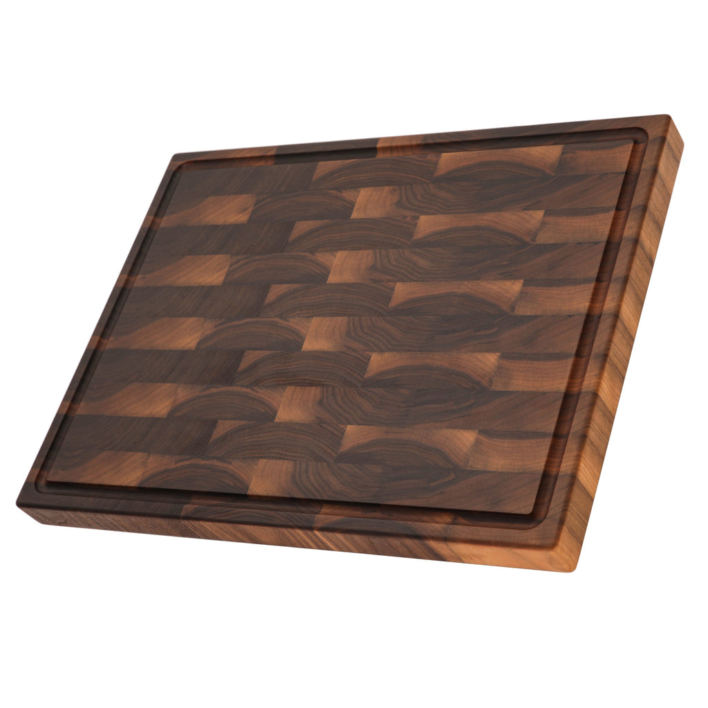 End grain walnut butcher block with a juice groove, 24 x 18 in, lying at an angle showing the 2 inch edge