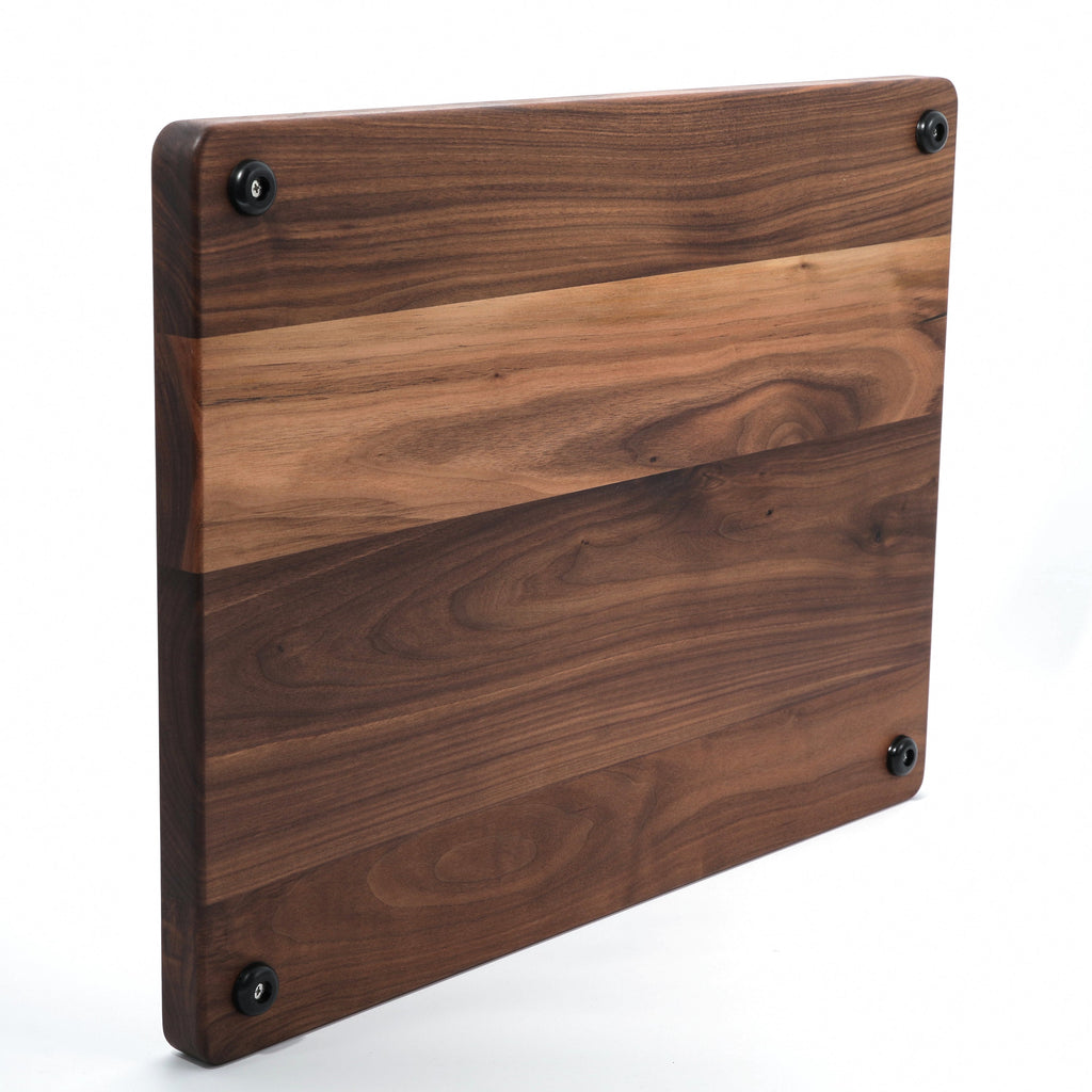Extra large thick walnut cutting board, 24 x 18 in, propped upright to show the underside corners