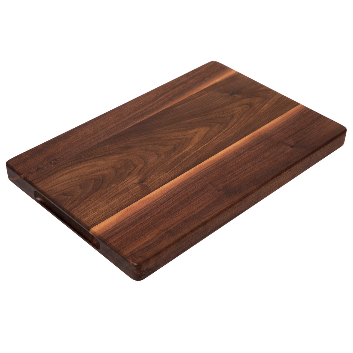 Thick walnut cutting board, 18 x 12 in, with side handle and light sapwood stripe, low angled view on white