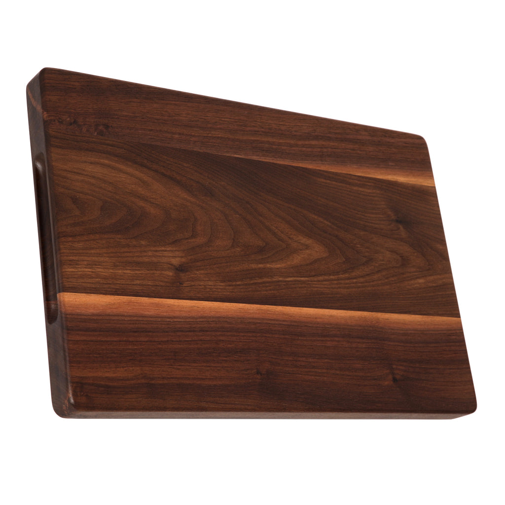 Thick walnut cutting board, 18 x 12 in, propped on its long edge to show the 1.25 inch thickness