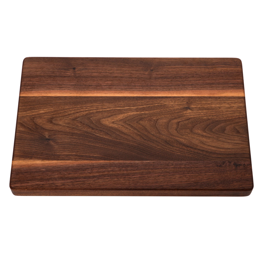 Thick walnut cutting board, 18 x 12 in, angled overhead view with a pale sapwood stripe across the grain