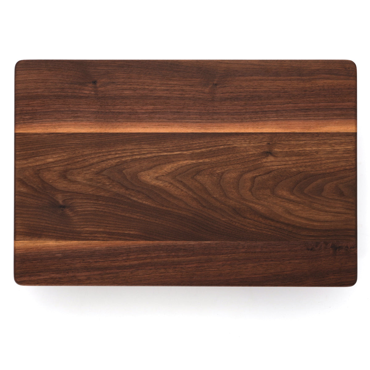 Thick walnut cutting board, 18 x 12 in, overhead view showing mixed dark and pale grain on white