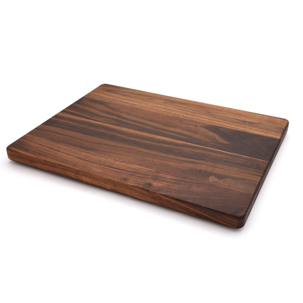 Extra large thick walnut cutting board, 24 x 18 in, angled view of the plain top with warm grain