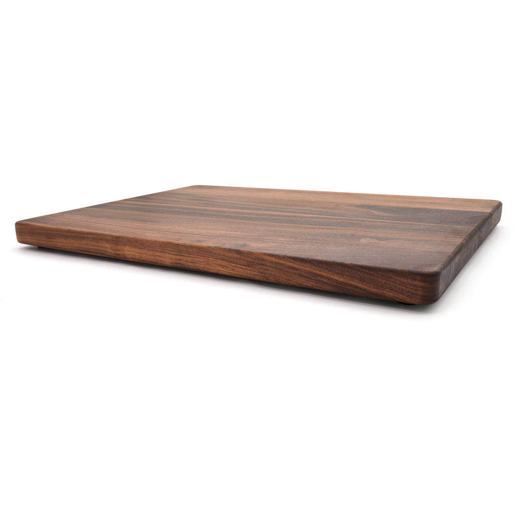 Extra large thick walnut cutting board, 24 x 18 in, low side view showing the 1.25 inch edge