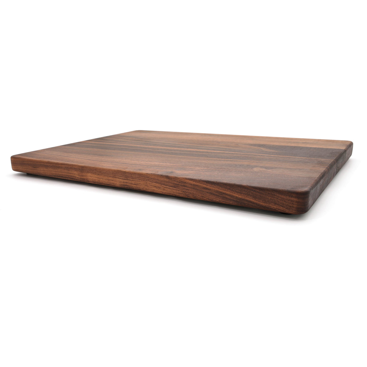 Extra large thick walnut cutting board, 24 x 18 in, low side view showing the 1.25 inch edge