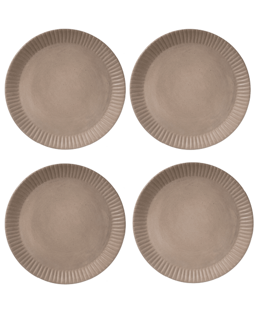 Four clay-toned ceramic dinner plates with hand-carved line rims, shown from above on a deep green ground