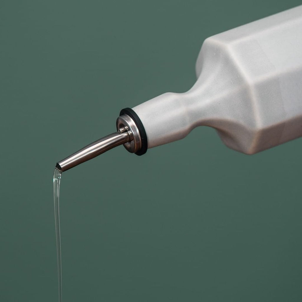 Porcelain Olive Oil Dispenser styled on a wood table with linen in a modern Southwest room