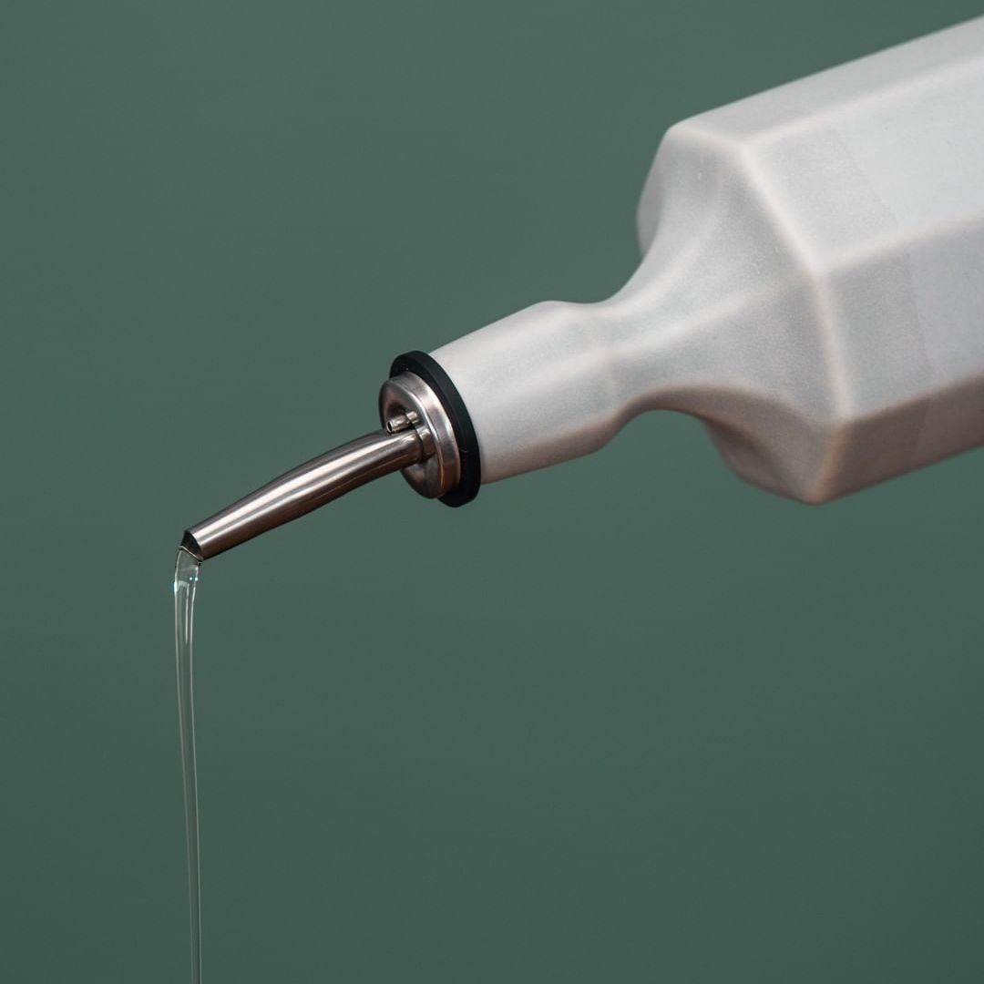 Porcelain Olive Oil Dispenser styled on a wood table with linen in a modern Southwest room