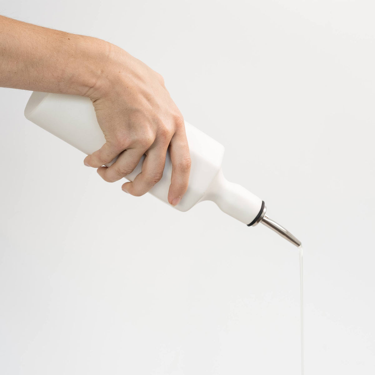 Porcelain Olive Oil Dispenser shown from a second angle against a pale neutral backdrop