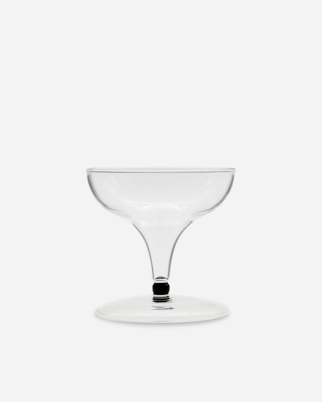 Single handblown coupe glass with a wide bowl and short dark-banded stem on a pale gray background