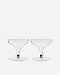 Pair of handblown coupe glasses with short stems and a dark accent band on a pale gray background
