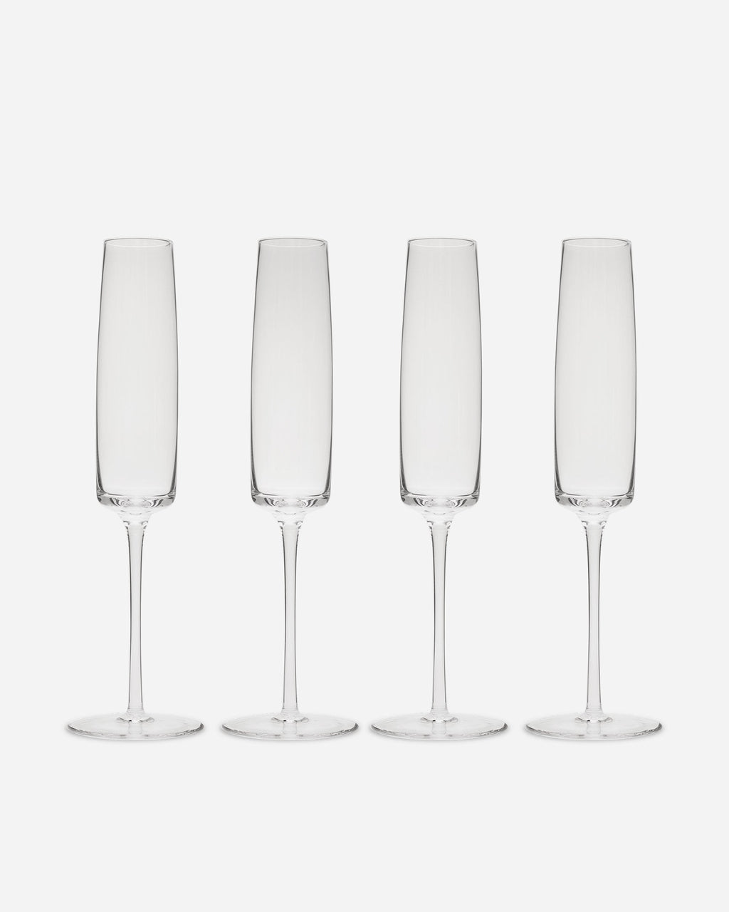 Four handblown crystalline champagne flutes with tall straight bowls and slender stems on a pale grey background