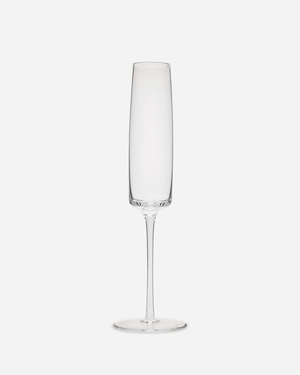 Single handblown champagne flute in clear lead-free crystalline glass with a long thin stem on a pale grey ground
