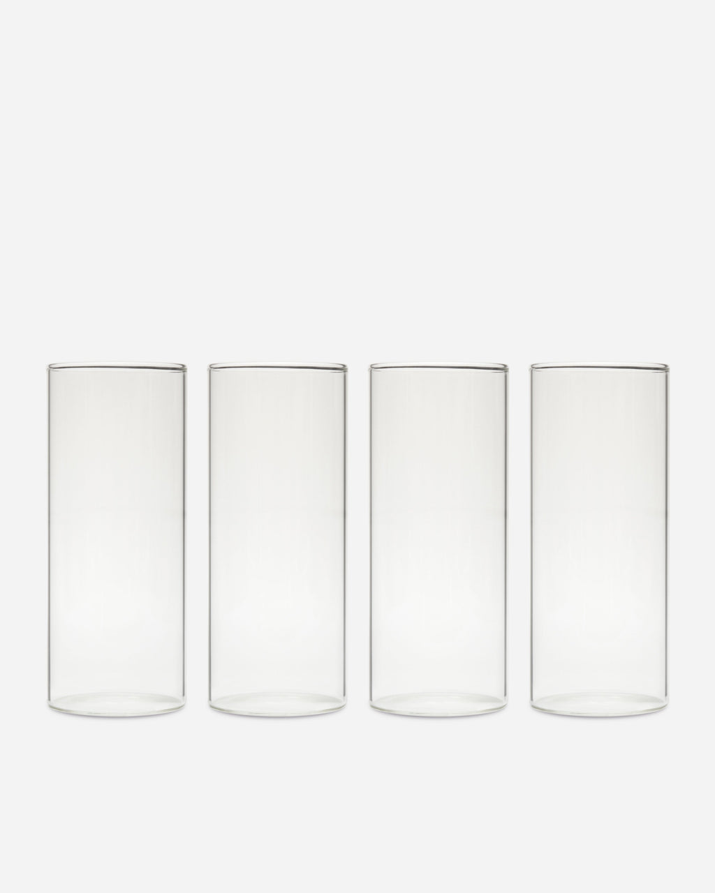 Tall Handblown Drinking Glassware photographed on a bone white surface in soft natural light