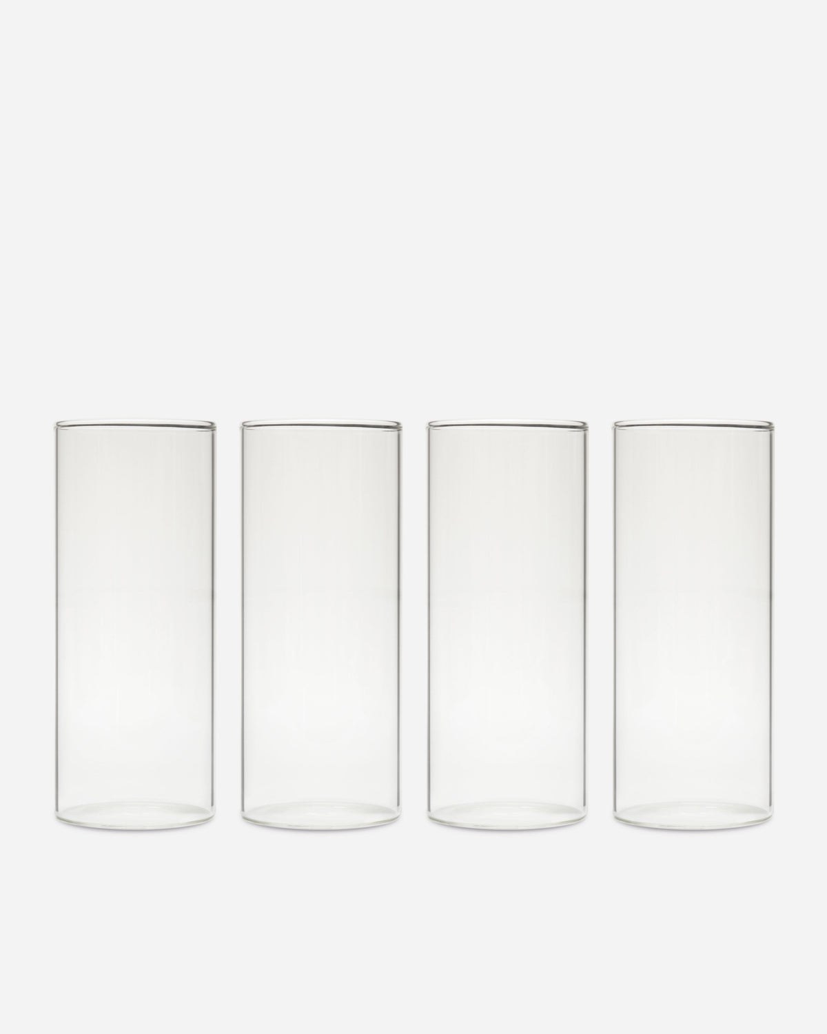Tall Handblown Drinking Glassware photographed on a bone white surface in soft natural light
