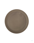 Round carved-rim ceramic platter in a warm clay-toned glaze seen from above against a dark green background