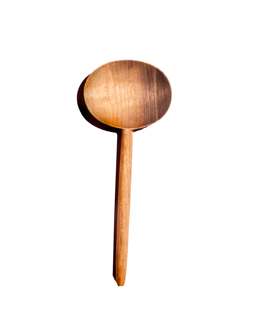 Single carved walnut oval serving spoon with warm honey-colored grain, shown from above against black