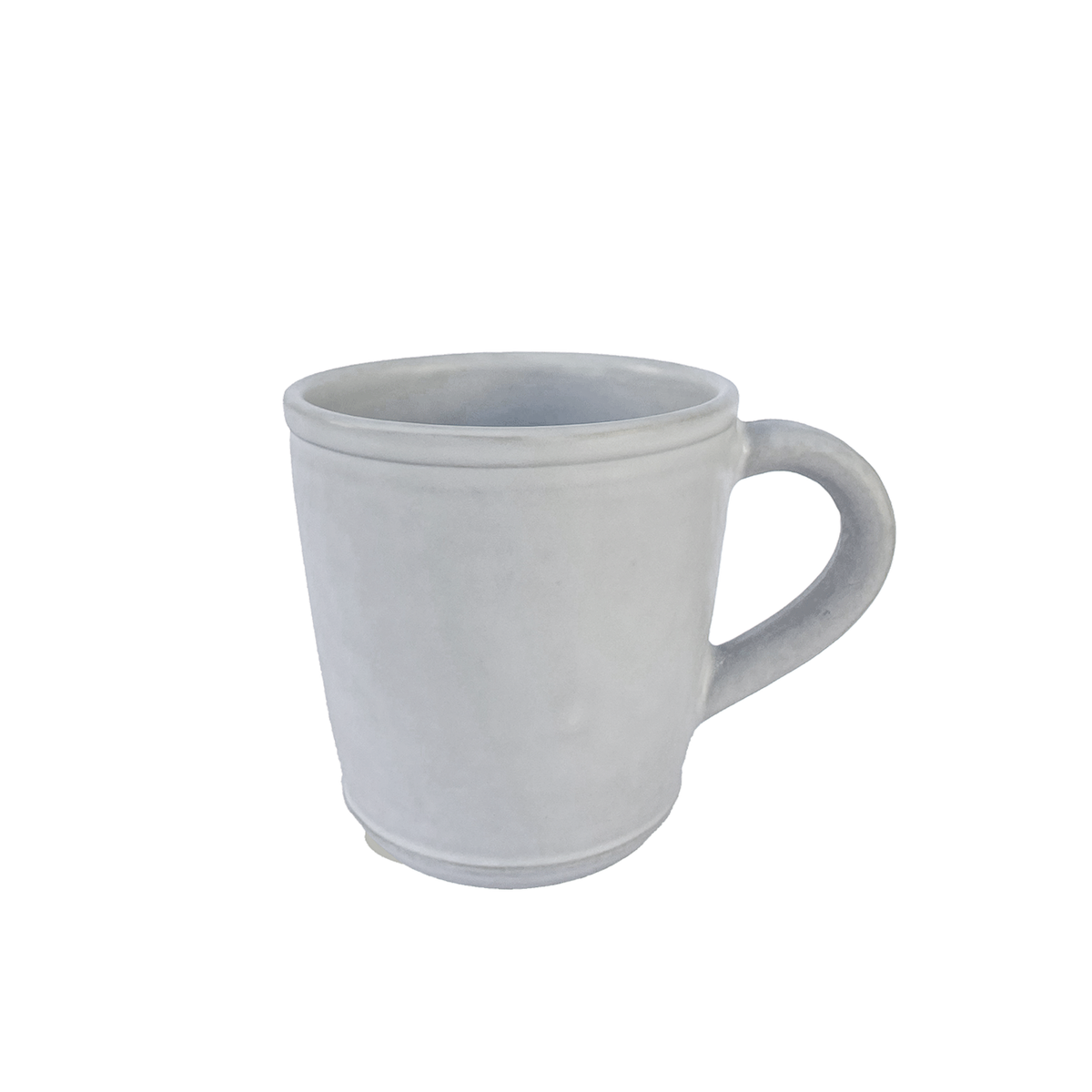 Handmade oval ceramic mug in matte white glaze with a ridged rim and base, handle to the right, on white