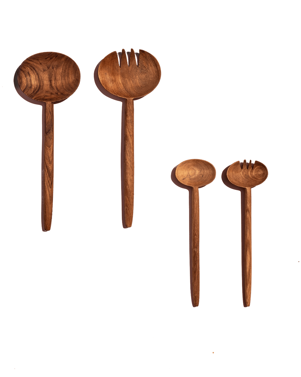 Two pairs of carved walnut salad servers in short and long lengths shown on a deep green background
