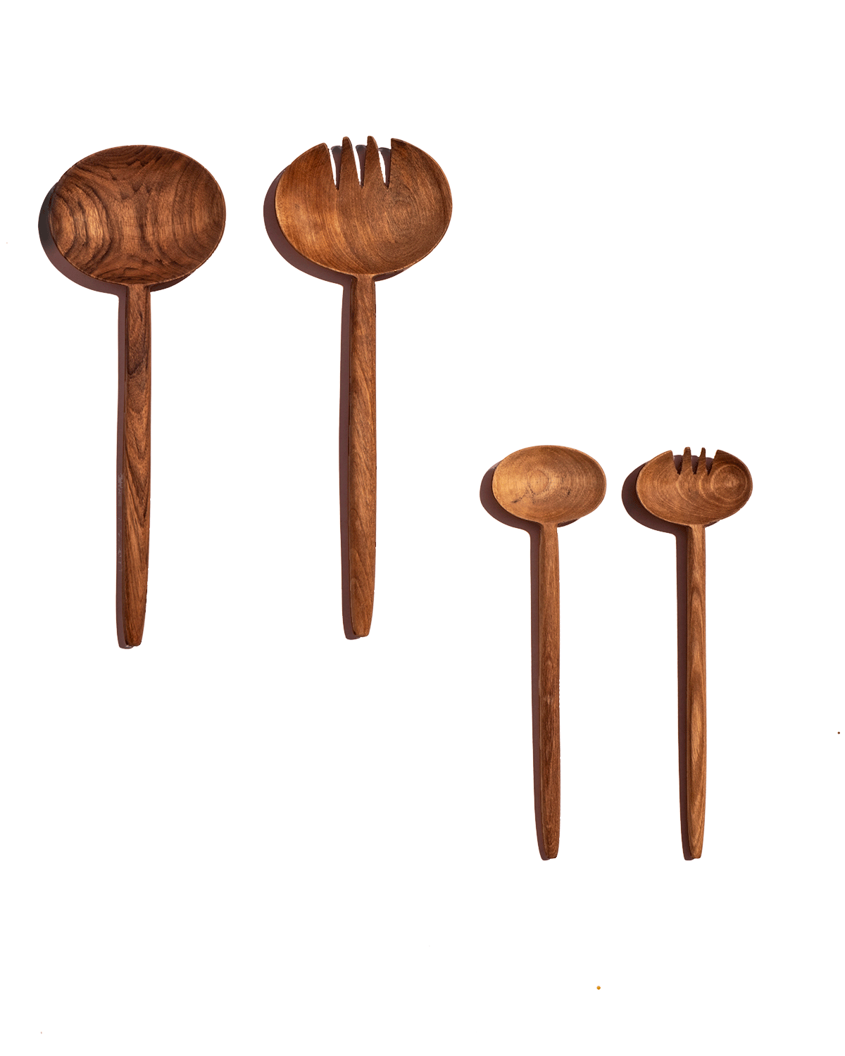 Two pairs of carved walnut salad servers in short and long lengths shown on a deep green background