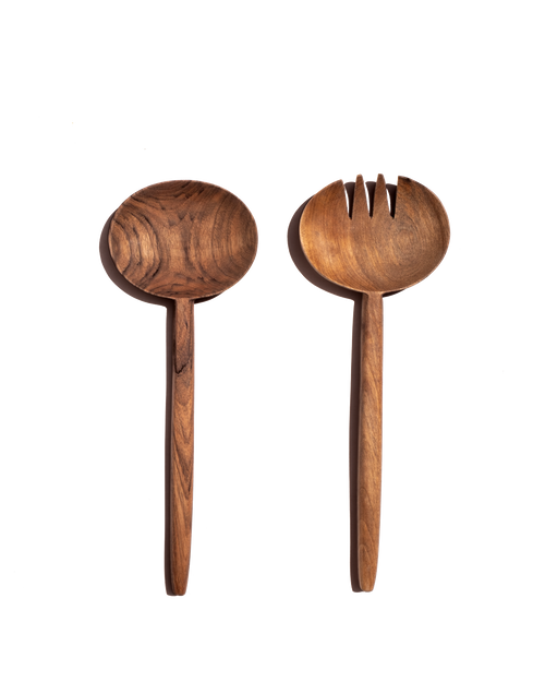 Walnut salad spoon and slotted fork with oval heads laid side by side on a black background