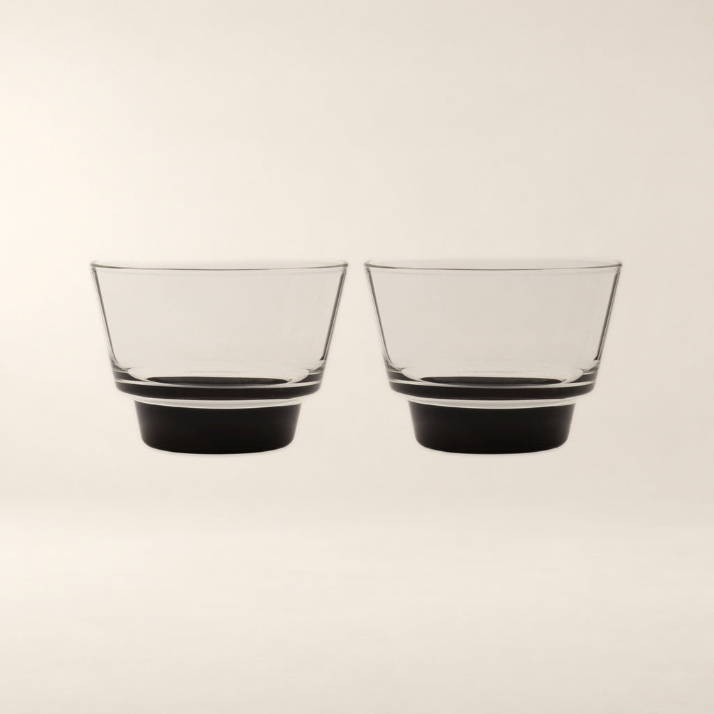 Cirrus Stackable Borosilicate Glass Cups, Black Base, Set of 2 on a warm bone background.