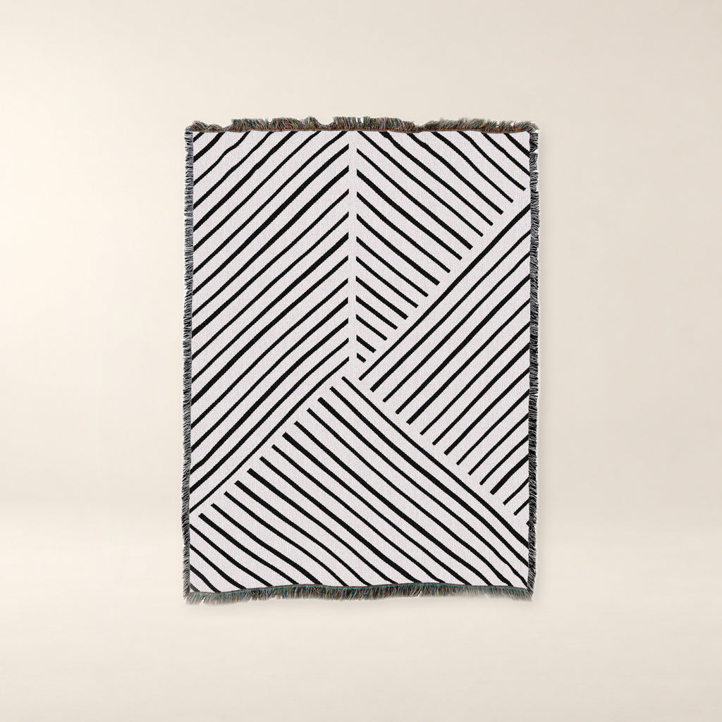 Diagonal Lines Woven Cotton Throw, Black and Ivory on a warm bone background.