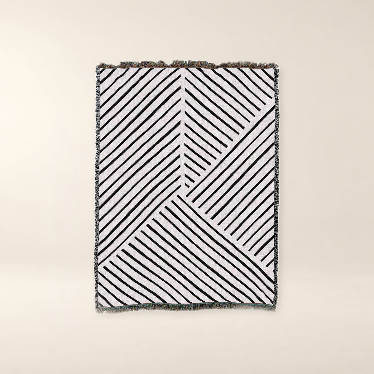 Diagonal Lines Woven Cotton Throw, Black and Ivory on a warm bone background.