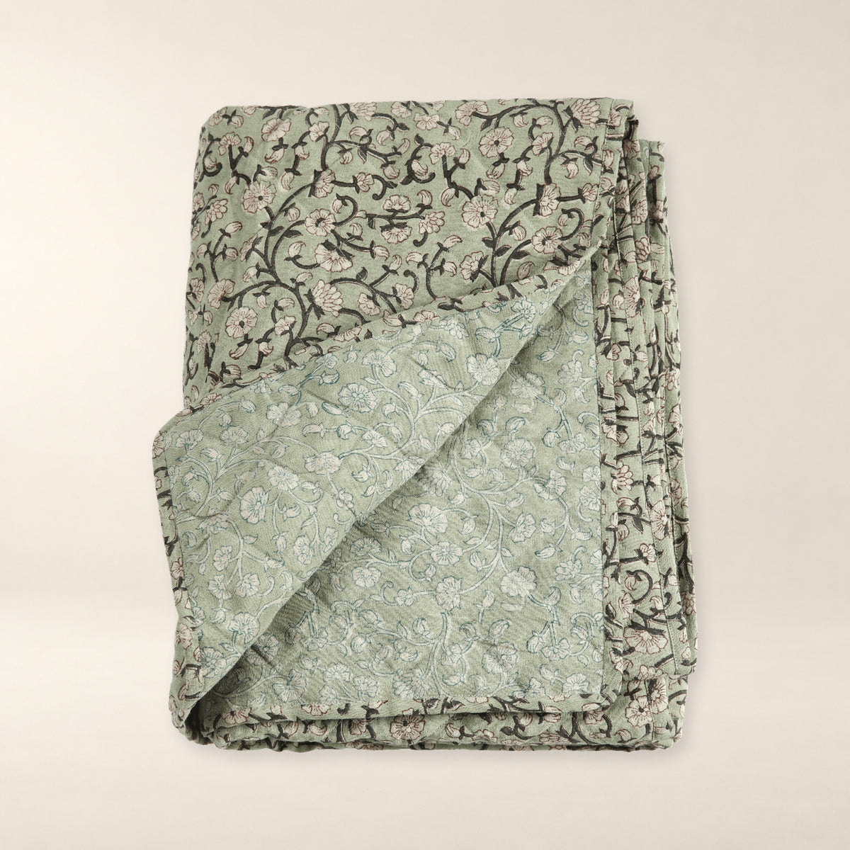 Keya Linen Block Print Quilted Coverlet on a warm bone background.