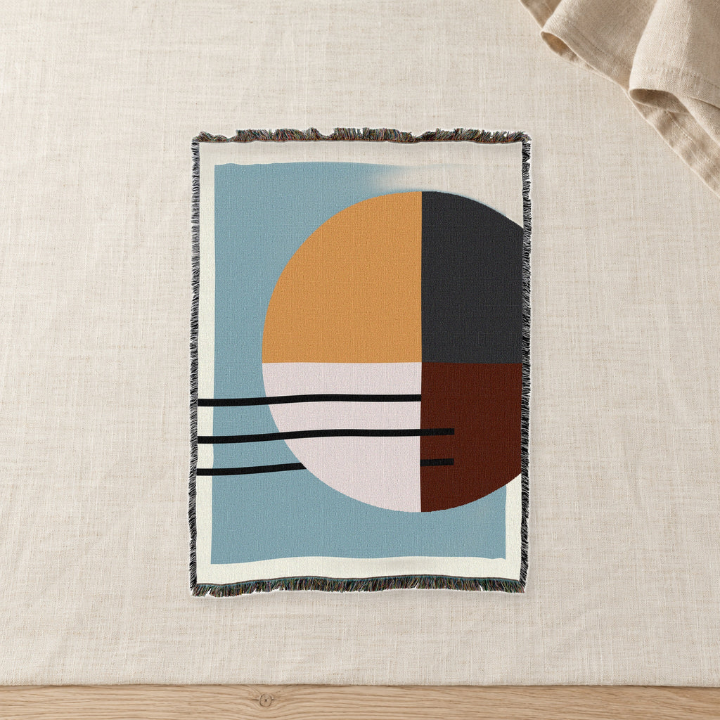 Quartered Sun Abstract Woven Cotton Throw on raw linen with a folded napkin.