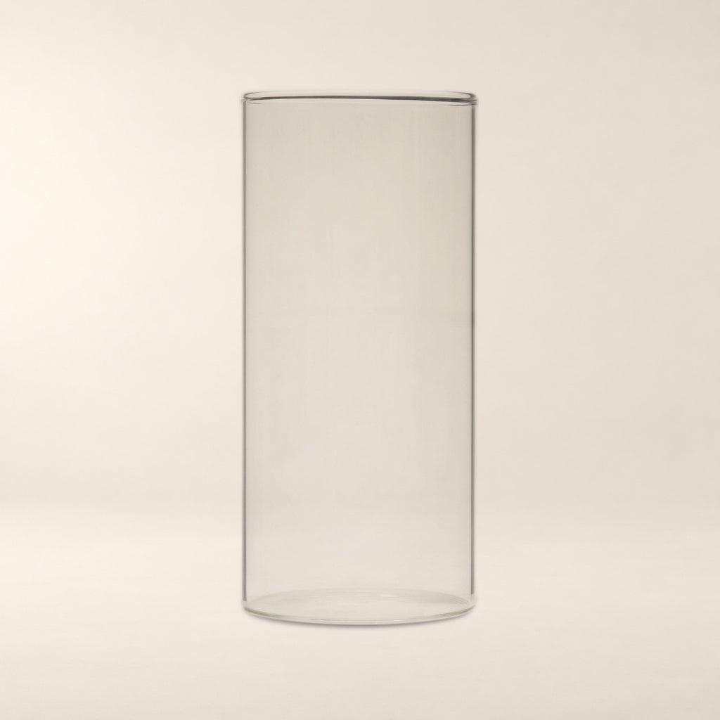 Sora Handblown Glass Cylinder Vase, 7 in on a warm bone background.