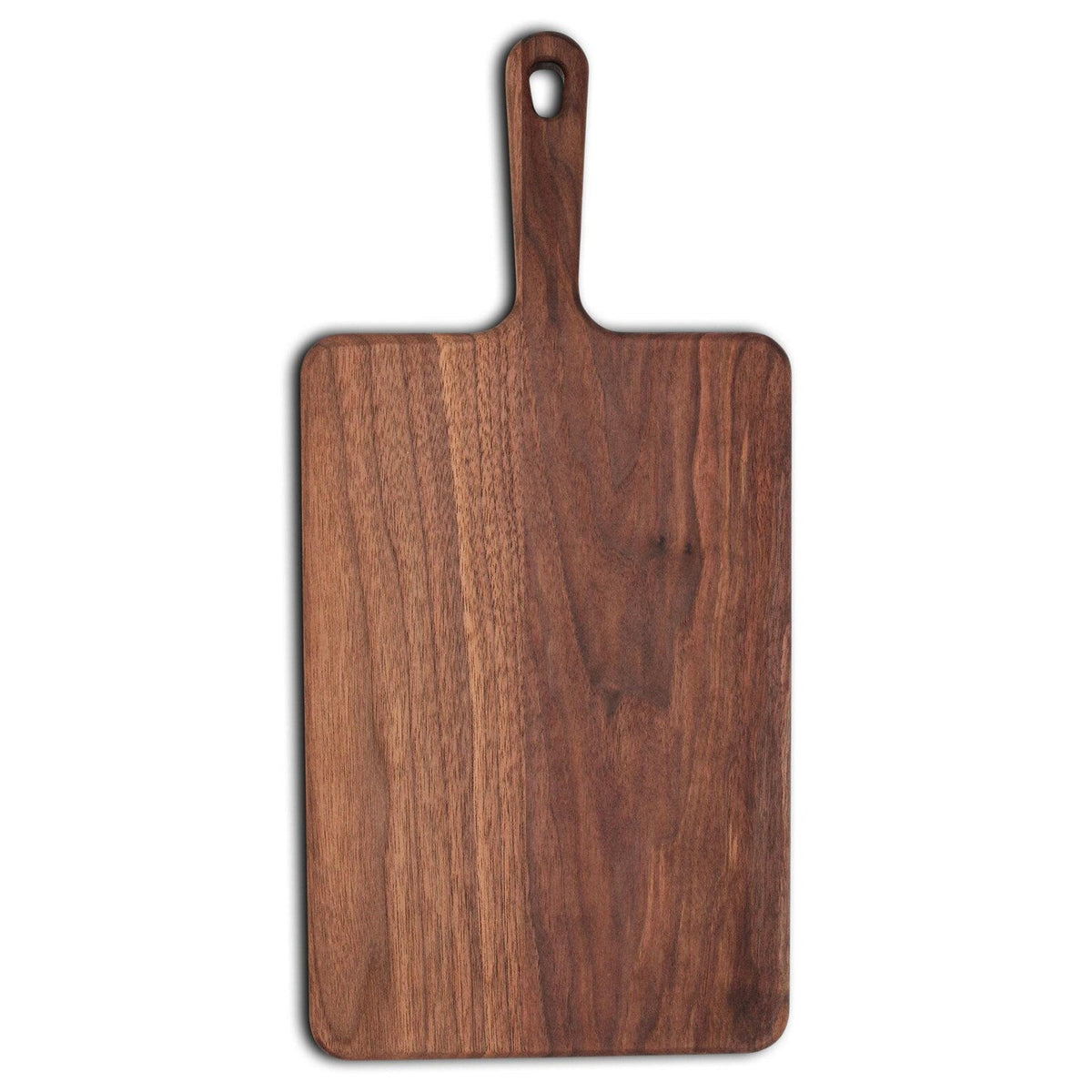 Wide walnut paddle serving board with a handle and hanging hole, straight overhead view on white