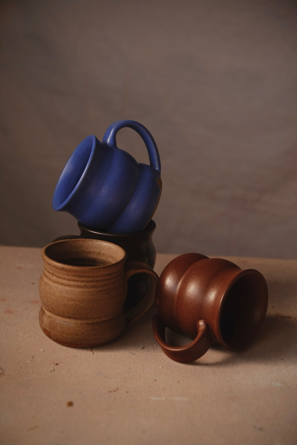 Hand-Thrown Stoneware Wave Mug photographed on a bone white surface in soft natural light